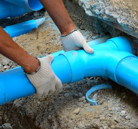 Plumber checking water pipes and connections